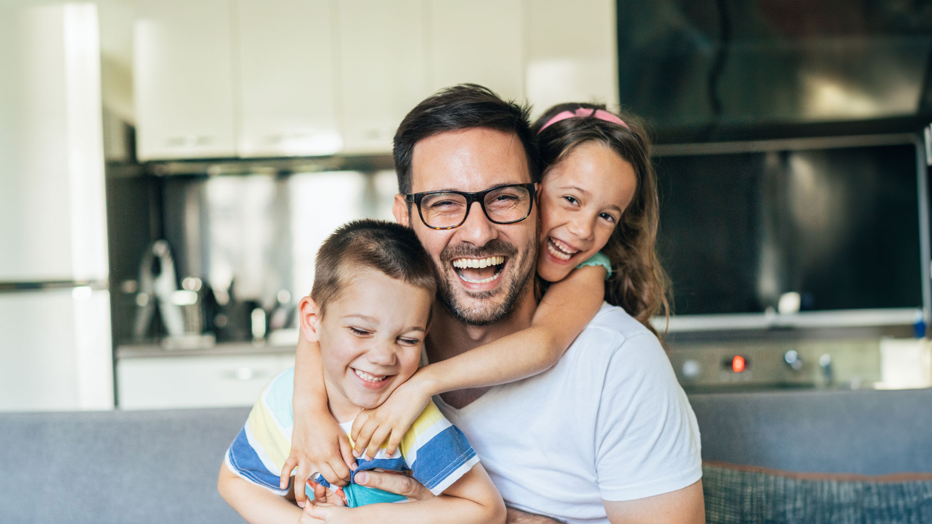 Father with two children smiling